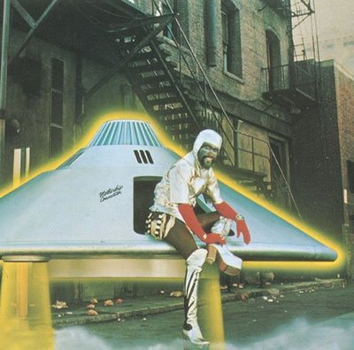 George Clinton dressed as the Star Child climbs out of the Mothership UFO